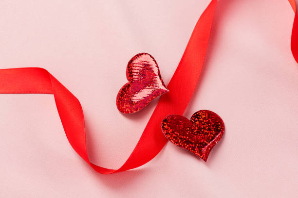 istock Two red hearts for Valentine's Day On a pink background 1203906231