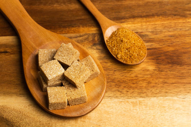 istock Brown sugar cubes on a wooden spoon 1203909635