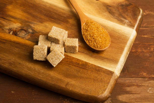 istock Brown sugar cubes on a wooden kitchen board 1203909749