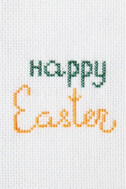 istock The inscription Happy Easter is embroidered on white cloth. 1203911341