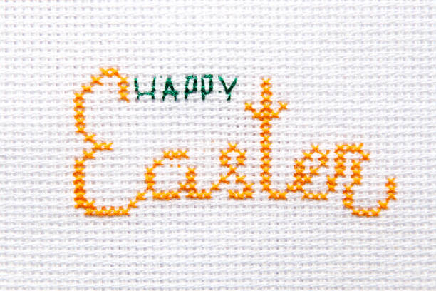 istock The inscription Happy Easter is embroidered on white cloth. 1203911379