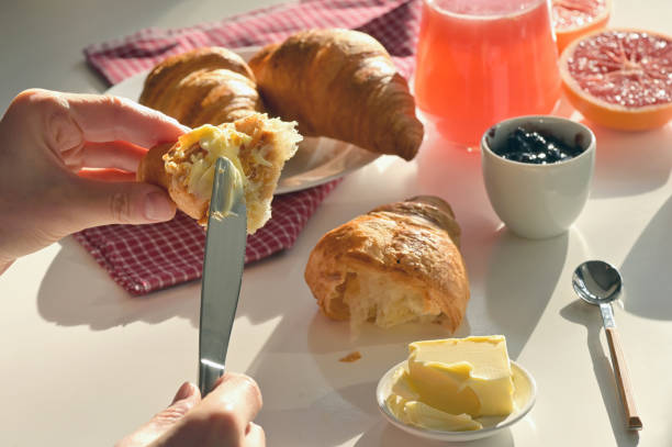 istock Breakfast With Juice And Croissant on White Table 1203911615