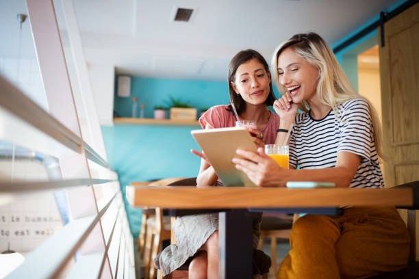 istock Happy young women friends having fun together, working, talking 1203914576