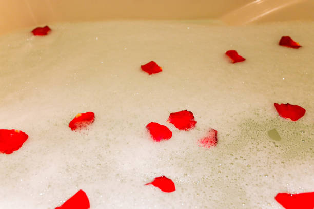 istock Rose petals are romantic in the bathtub. 1203914749
