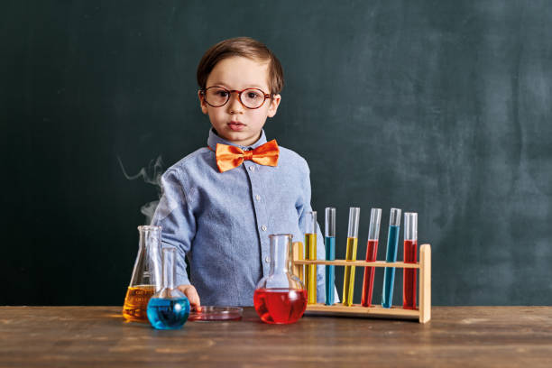 istock Cute child scientist learning science at classroom with chemistry tools. Education is science. 1203915381
