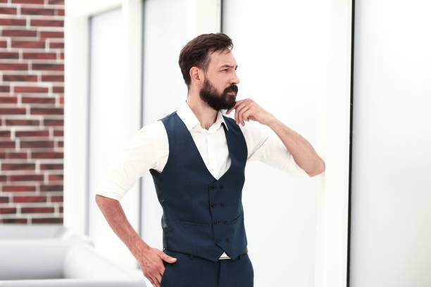 istock dreaming businessman standing near the office window 1203915393