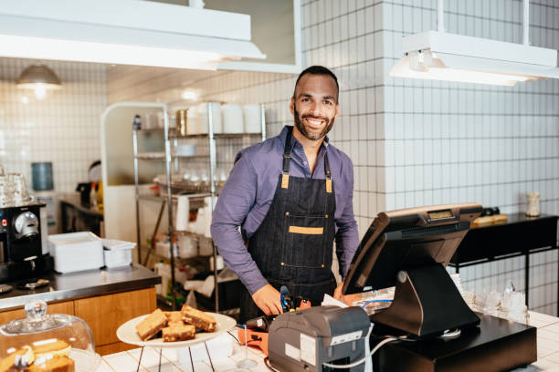 istock Latino barista working in cafe 1203915964