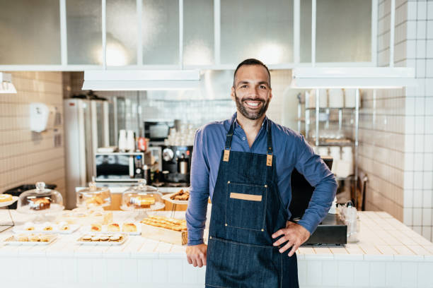 istock Latino barista working in cafe 1203915990