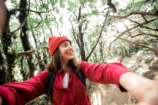 istock Woman having fun while travel in the forest 1203916085