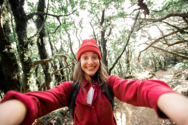 istock Woman having fun while travel in the forest 1203916135
