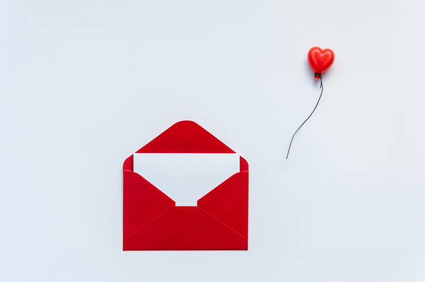 istock Red envelope with blank postcard and heart balloon on white background. 1203918278