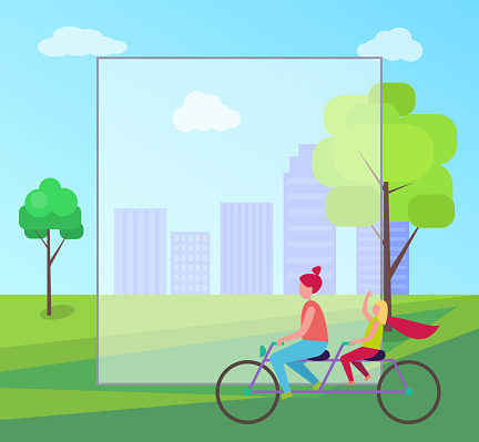 Redhead mother and her young blonde daughter riding purple tandem bicycle on background of skyscrapers in city park with frame for text.
