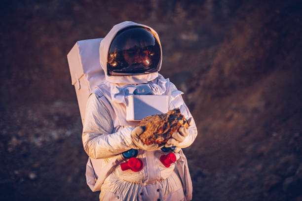 istock Astronaut holding a rock on Mars 1203918885