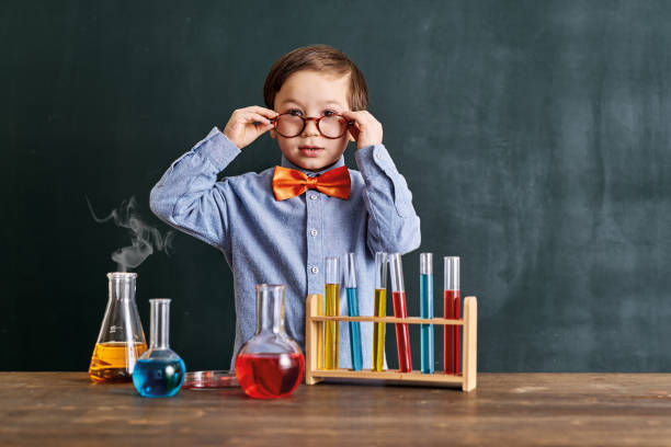 istock Cute child scientist learning science at classroom with chemistry tools. Education is science. 1203918943