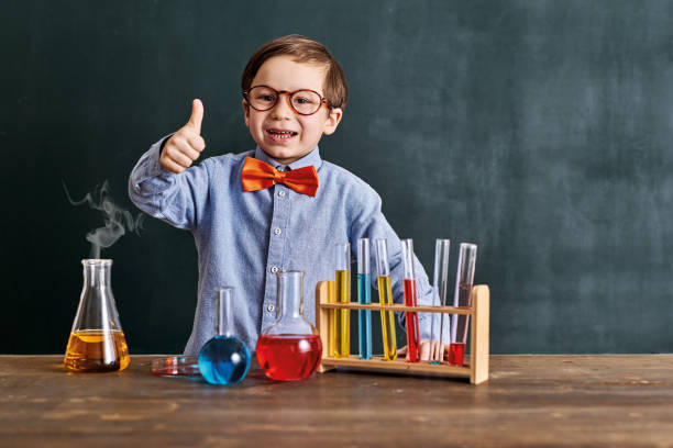 istock Cute child scientist learning science at classroom with chemistry tools. Education is science. 1203919620