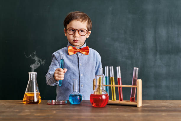 istock Cute child scientist learning science at classroom with chemistry tools. Education is science. 1203919909