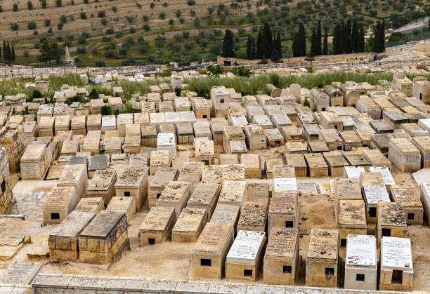 JERUSALEM, ISRAEL - MAY 16, 2018: Orthodox Jew  visiting the graveyards in the Jewish Cemetery on the Mount of Olives where according to midrash the Resurrection of the Dead would begin
