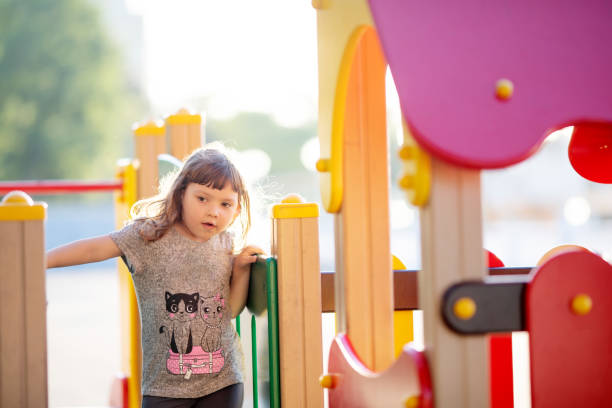 istock Little kid on playground, children's slide 1203920194