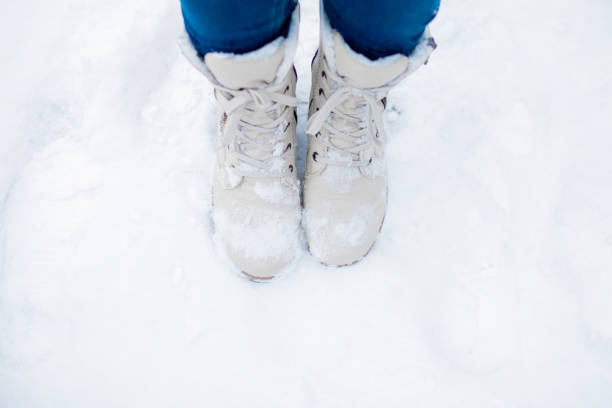 istock White boots in the snow, closeup 1203921025