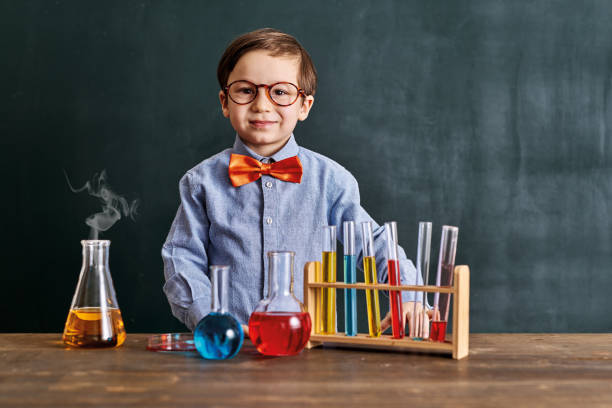 istock Cute child scientist learning science at classroom with chemistry tools. Education is science. 1203921748