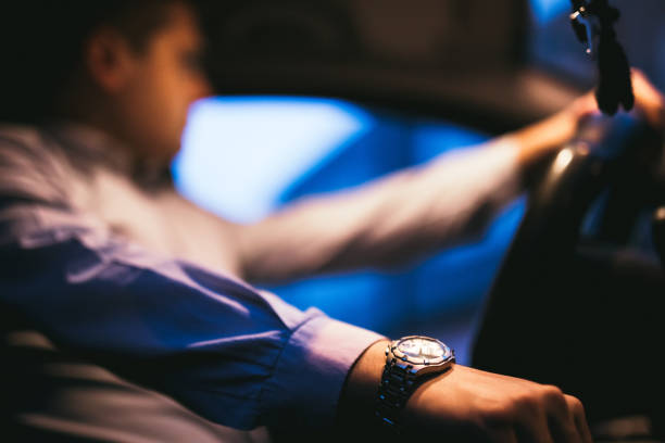istock Dark elegant man driving car 1203922761