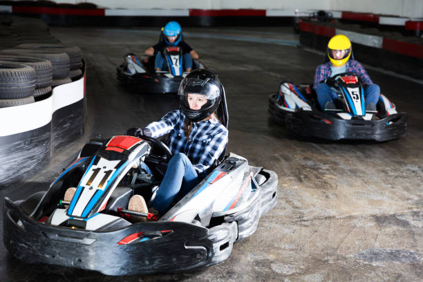 Young people driving sport cars for karting Young glad people driving sport cars for karting  in a circuit lap in sport club go carting stock pictures, royalty-free photos & images
