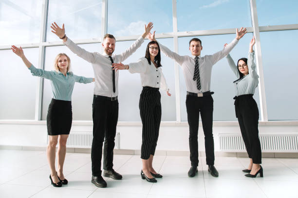istock young business team standing in an empty new office. 1203925817