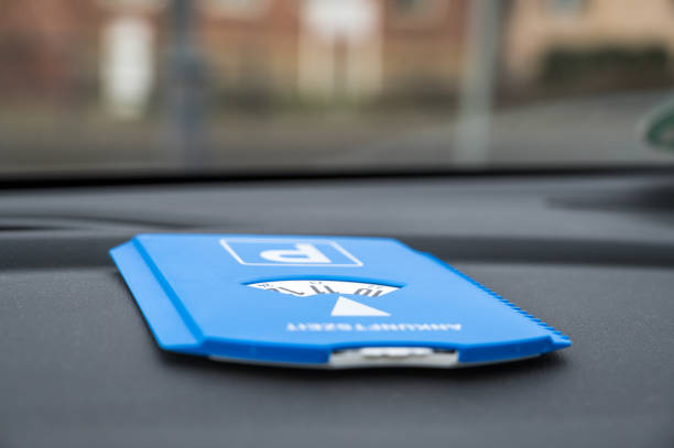 Blue parking disc lies on the dashboard of a car