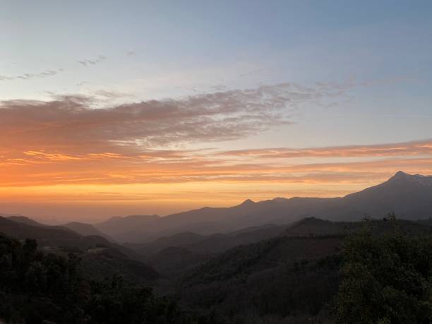 istock Orange sunrise cloudscape on a winter mountain scenic 1203926932