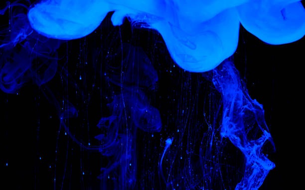 istock Blue phantom abstract background. Colored space background. Blue watercolor ink in water on a black background. 1203927378