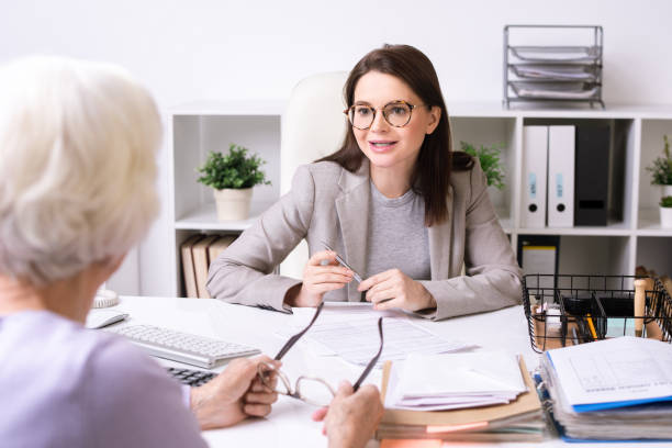 istock Social worker talking to senior lady 1203927411