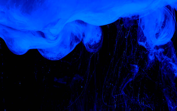 istock Blue phantom abstract background. Colored space background. Blue watercolor ink in water on a black background. 1203927433