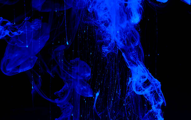 istock Blue phantom abstract background. Colored space background. Blue watercolor ink in water on a black background. 1203927475