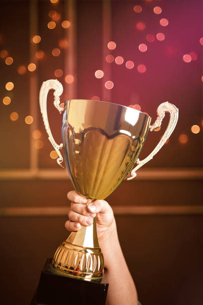 istock Cute child holding a golden trophy. He is winner. 1203928239
