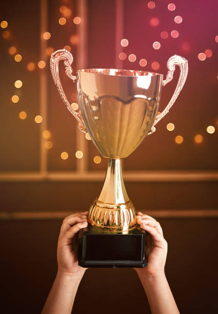 istock Cute child holding a golden trophy. He is winner. 1203928307