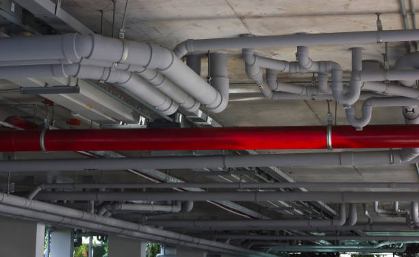 istock Construction work. Water pipe system. System of gray sanitary pipes in the building. 1203928554