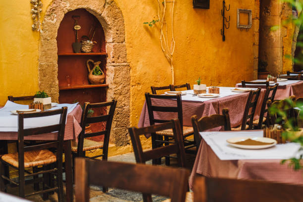 istock Rustic / mediterranean restaurant tables. Colorful walls and rustic restaurant decoration 1203928617