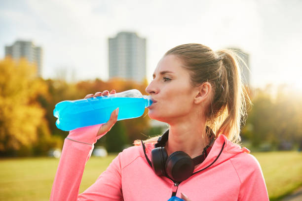 istock Woman taking a sip of refreshing water 1203930127