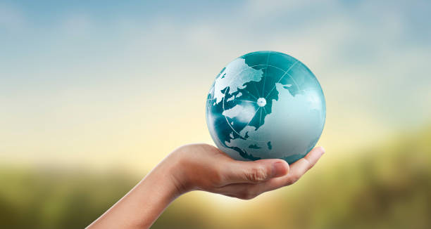 istock Globe ,earth in human hand, holding our planet glowing 1203933542