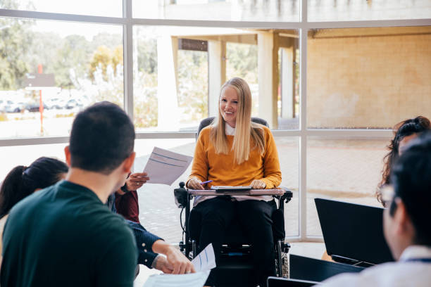 istock Female Wheelchair User in Group Discussion 1203933817