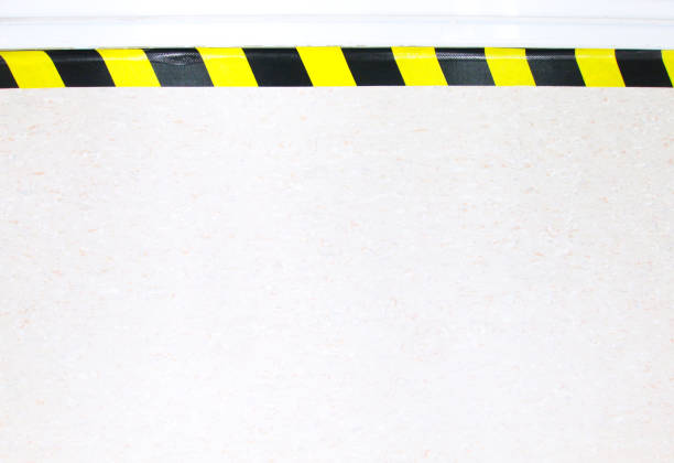 istock Warning hazard construction stripes sign or symbol texture isolated in granite concrete floor background, for safety first in laboratory walk way to watch out your step. Workplace safety concepts. 1203933885