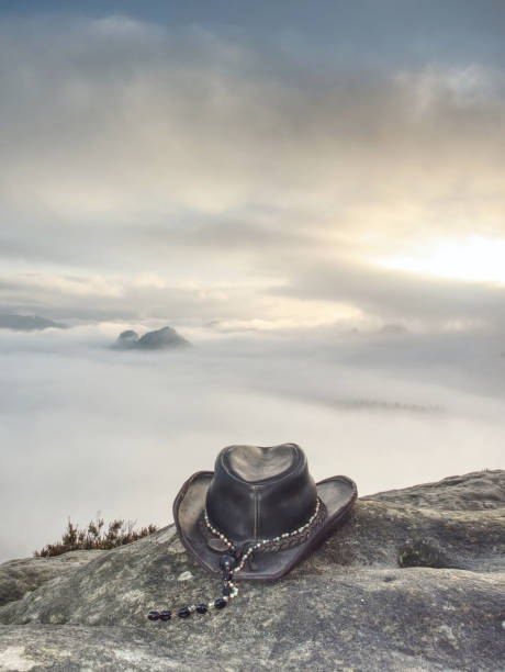 istock Cowboy hat ready on the rock 1203934083