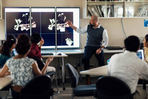 istock Mature Professional Presents Scientific Findings 1203934292