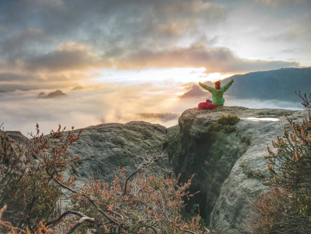 hiker man relaxing and take a breath after climbing the mountains.