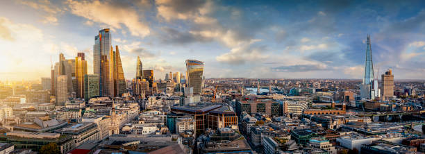 The skyline of London, United Kingdom, during sunset time The iconic skyline of London, United Kingdom, during sunset time with golden light and reflections in the modern skyscrapers panoramic stock pictures, royalty-free photos & images