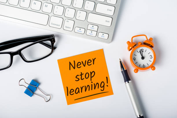 Never stop Learning - written message on white desk workplace. E-learning education concept Never stop Learning - written message on white desk workplace. E-learning education concept. continuity stock pictures, royalty-free photos & images