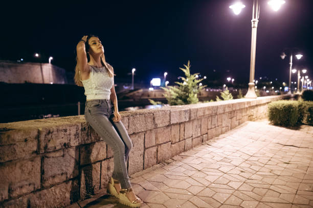 Young Caucasian woman posing by the river.