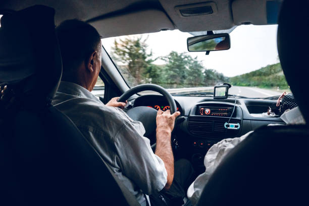 istock Senior man driving car 1203940290