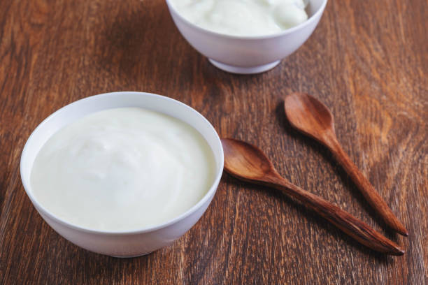 istock Natural yogurt On a wooden background 1203940542