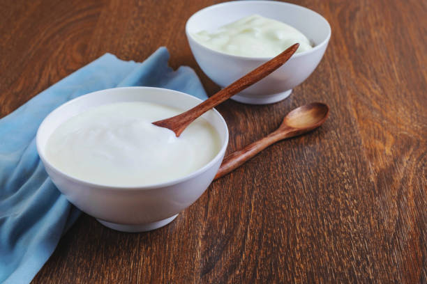 istock Natural yogurt On a wooden background 1203940547